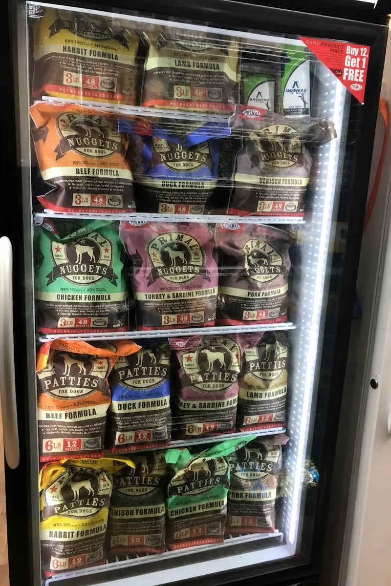 Freezer case of raw frozen pet food nuggets and patties at Paradise Poochie