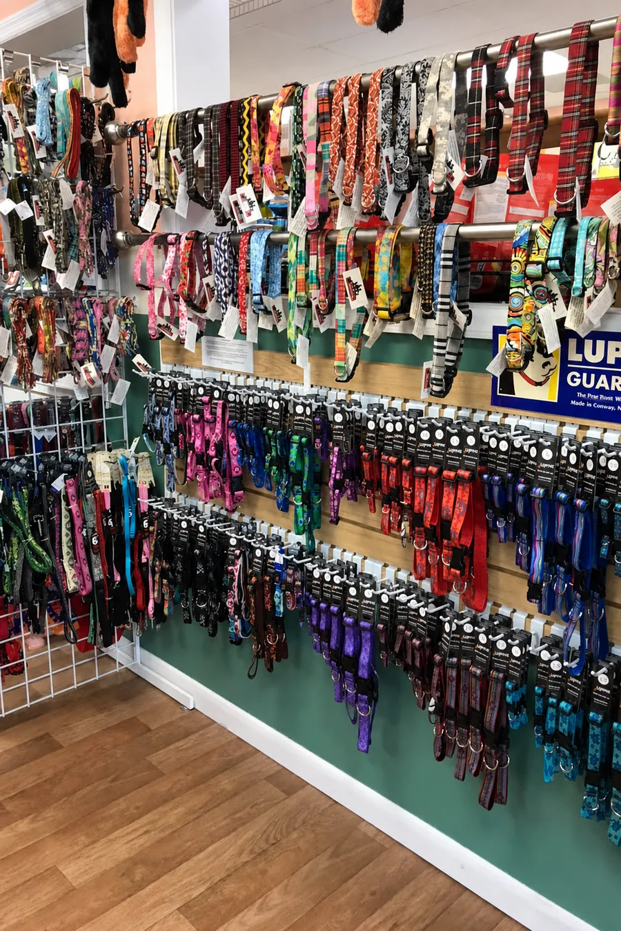 A wall of patterned dog collars, leashes and harnesses inside Paradise Poochie