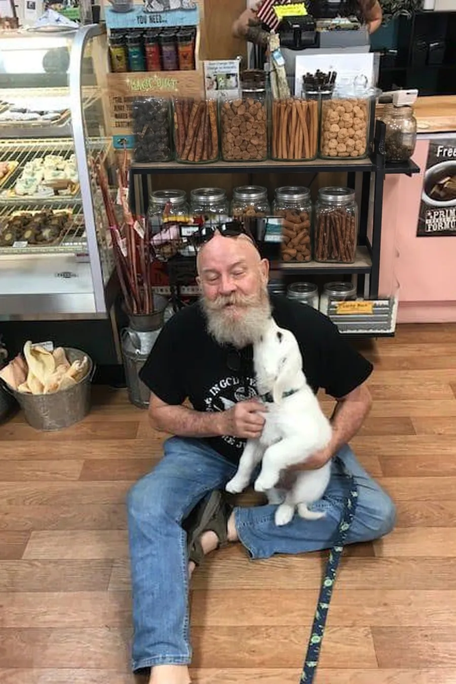 Tommy Brennan, owner of Paradise Poochie, with a puppy in the shop